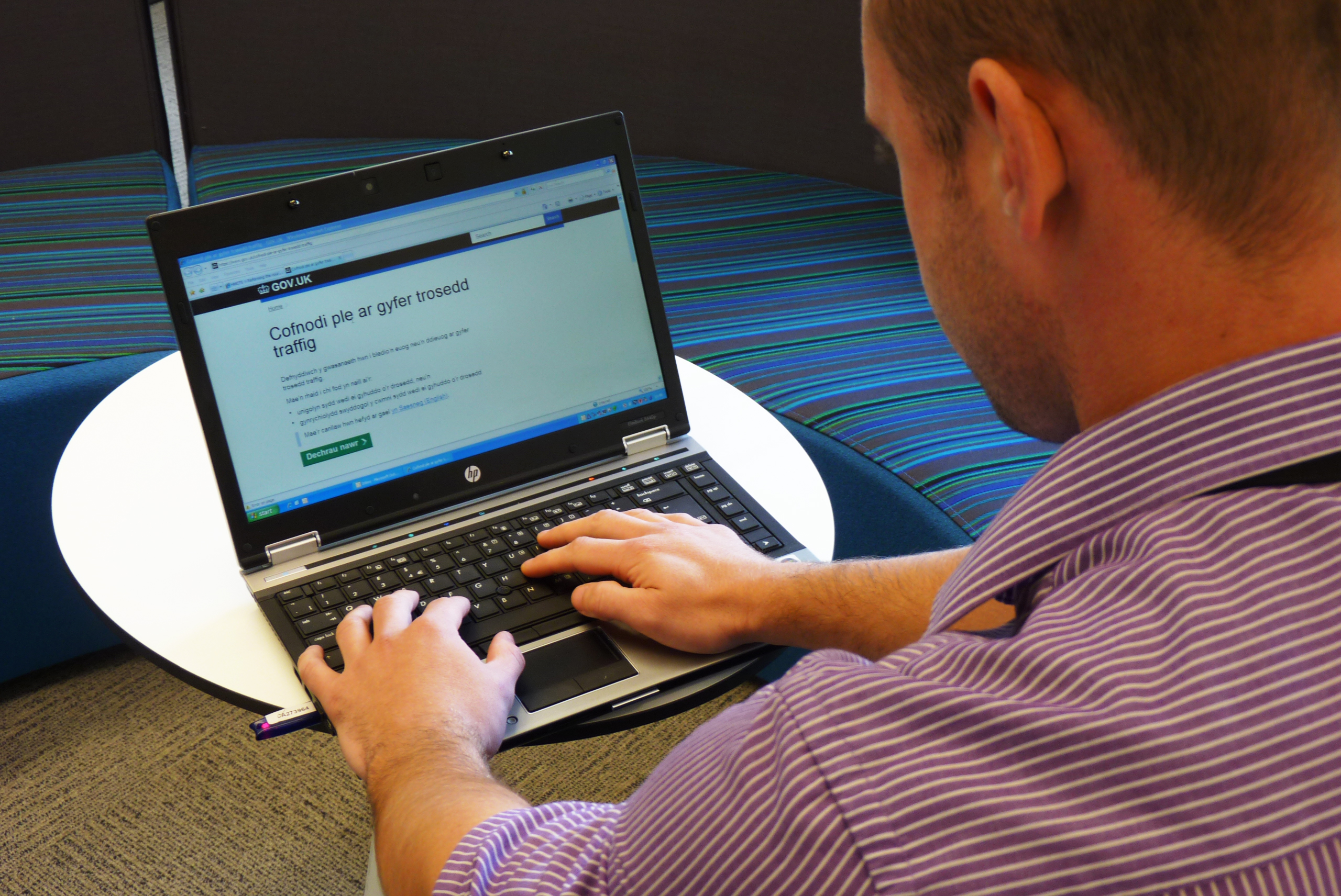 man sitting in front of a laptop on the internet