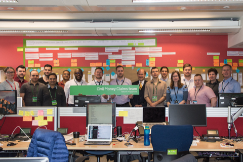 group of people standing behind desks