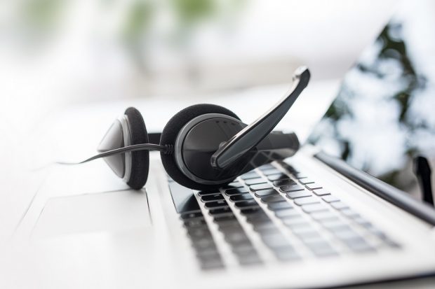 Headset on laptop computer keyboard.