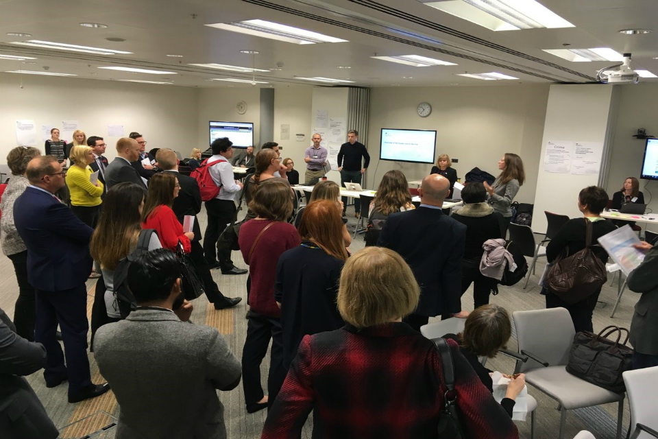 People standing in a room at the public user event in Nov 2018.
