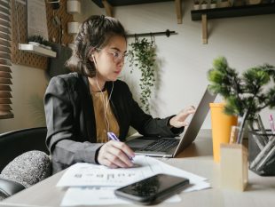 Woman sitting next to laptop