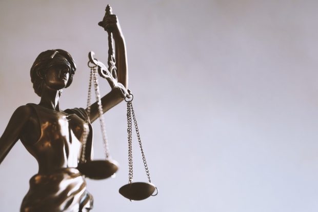 photograph of woan statue holding scales of justice