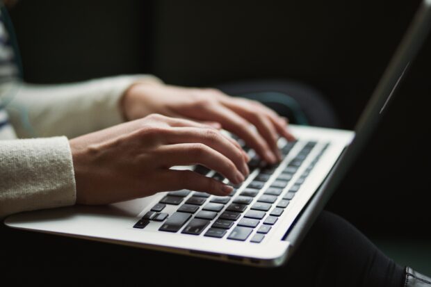 Person typing on laptop