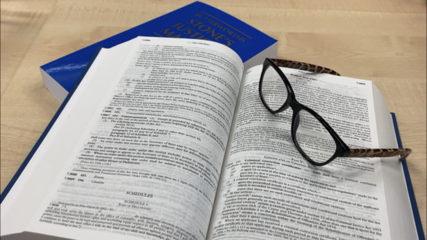 Image of a legal publication open with glasses on the side