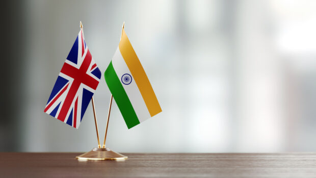 Indian and British flag pair on desk.